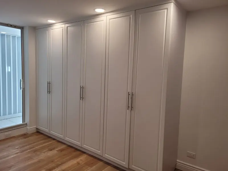 Floor-to-ceiling storage cabinets with flush doors