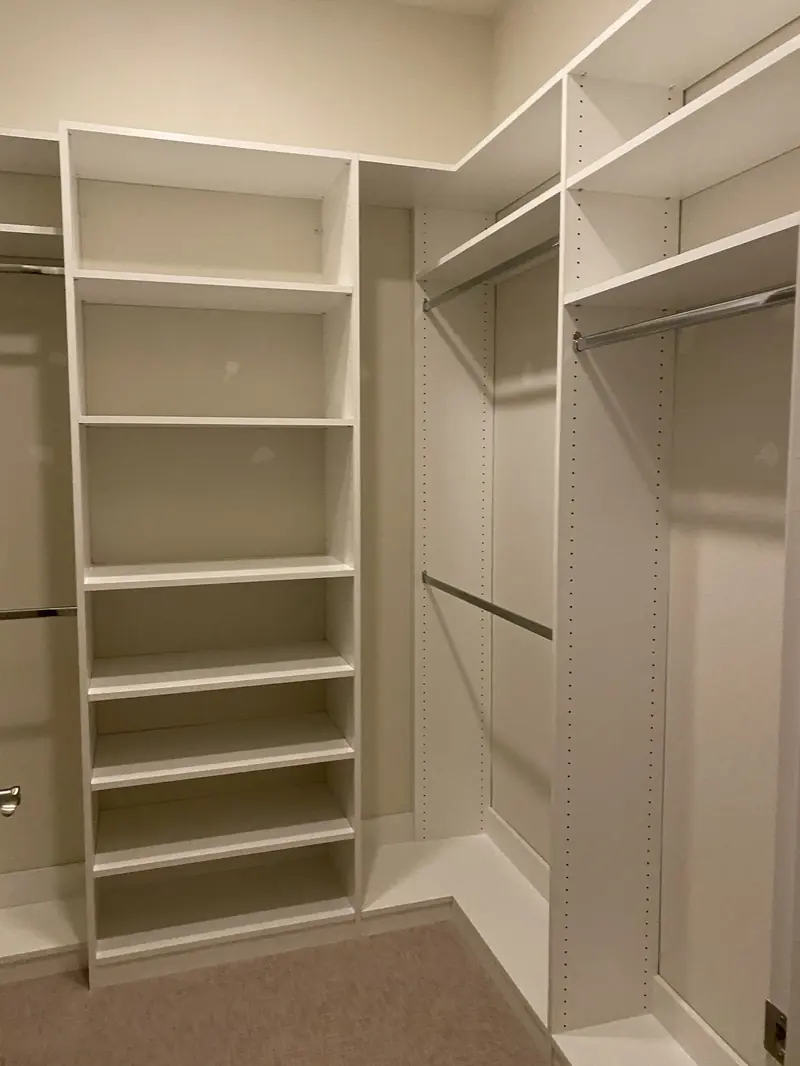 Custom walk-in closet with open shelving and double hanging rods