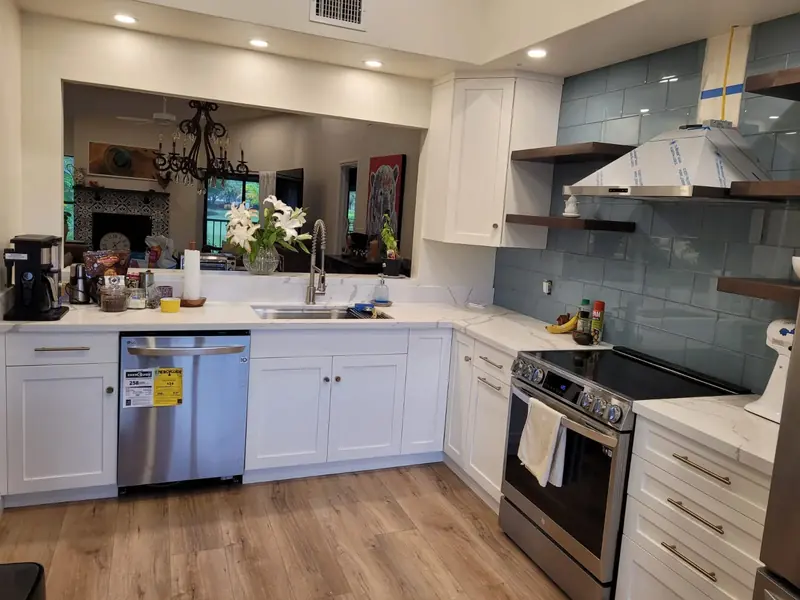 White kitchen with open wood shelves