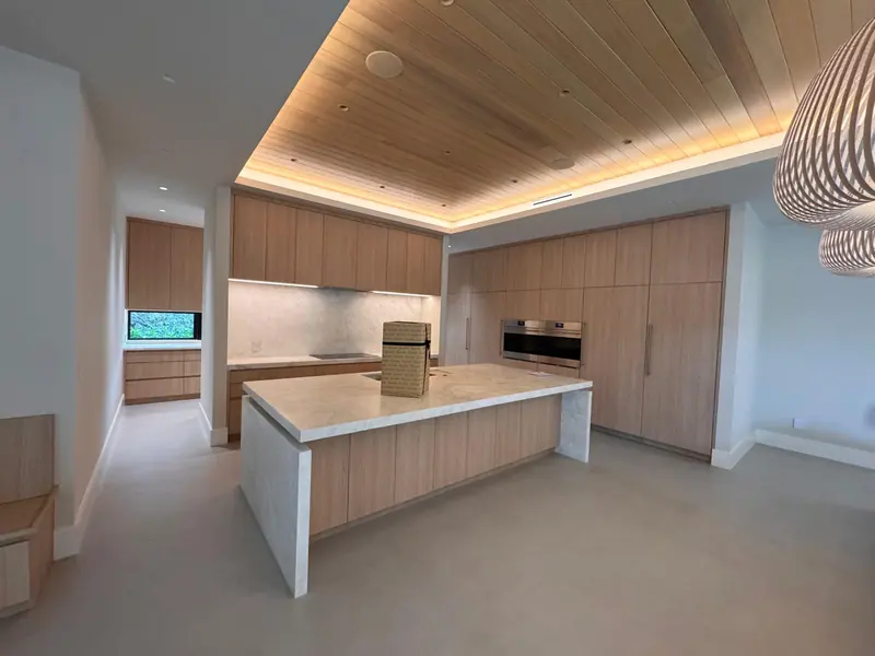Open white oak kitchen with island and integrated tall cabinets by Eco Woodwork & Design