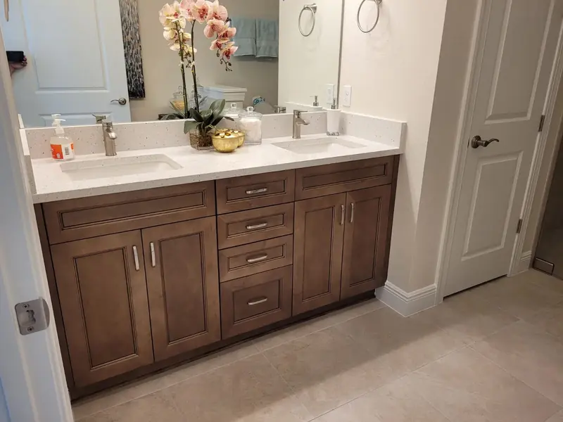 Walnut-finish custom bathroom vanity with double sinks and drawers