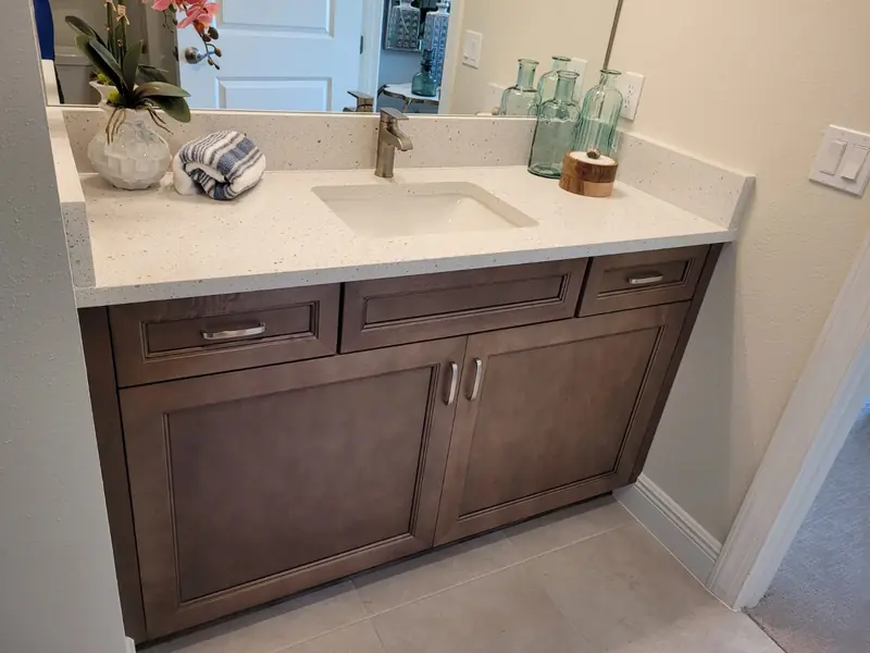 Custom wood bathroom vanity with double drawers and a stone top