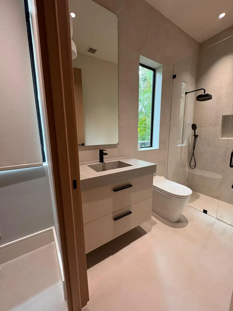 Floating bathroom vanity with a stone countertop by Eco Woodwork & Design