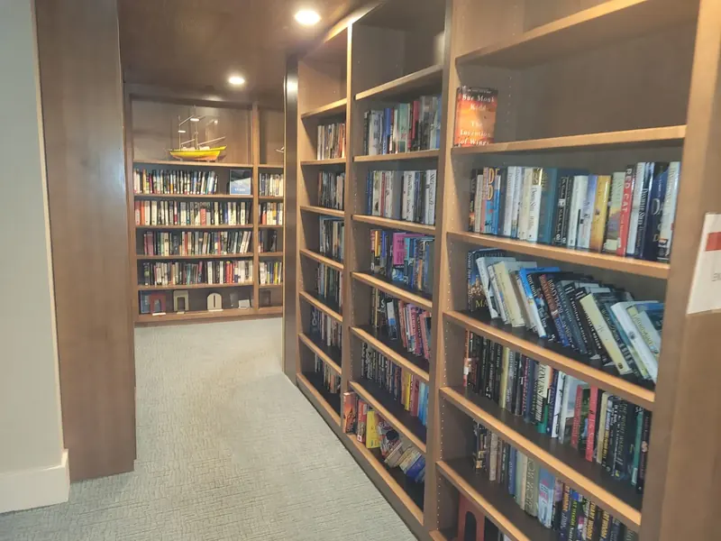 Floor-to-ceiling wood library shelving built into a residential space