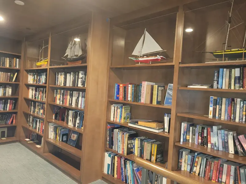 Wood library with floor-to-ceiling bookshelves and display niches
